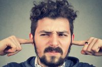Image of man plugging ears